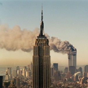 ** FILE ** The twin towers of the World Trade Center burn behind the Empire State Buildiing in New York in this Sept. 11, 2001, file photo. For a few months in 2001, architects worried that the era of the super-skyscraper was over. Even as ash from the World Trade Center still swirled, it was clear that the high floors of the twin towers had been a deadly trap. Experts wondered if anyone would ever build tall again. The answer was quickly revealed to be an emphatic, "yes." (AP Photo/Marty Lederhandler, File)